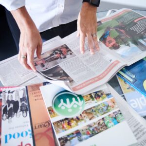 news magazines and strategic plans stacked up on a desk