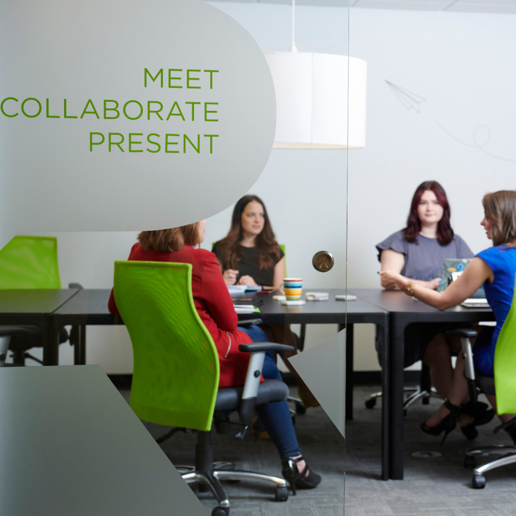 four women gather around the table to discuss a crisis plan